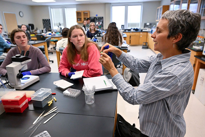 Students working with professor in lab