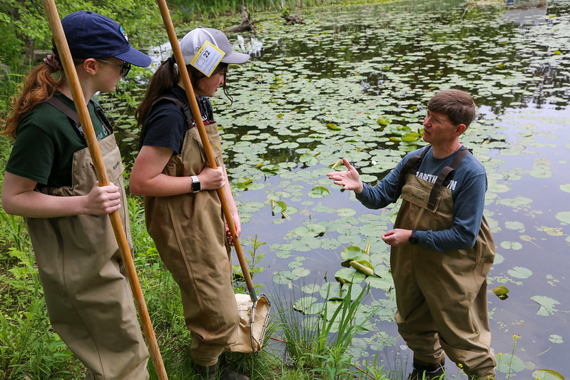 Professor and students working in lake