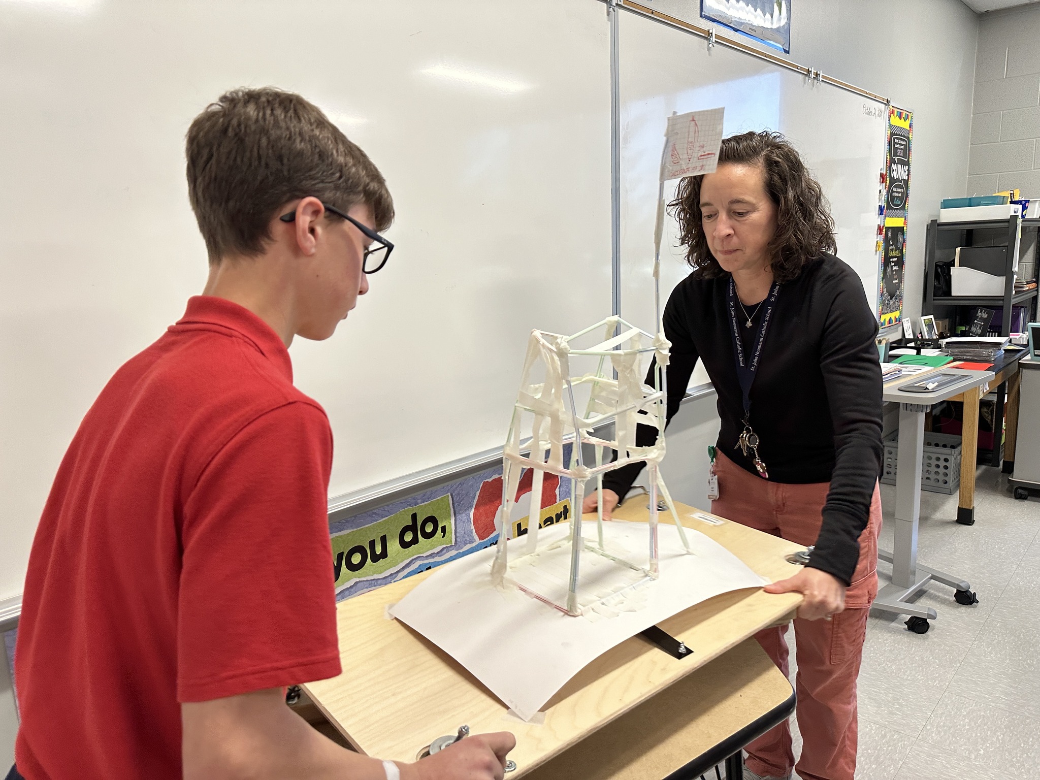 student and teacher using equipment