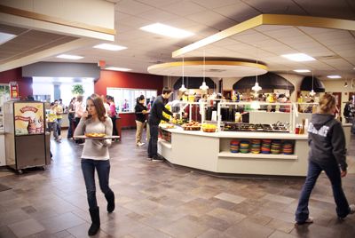 inside of the marketplace at elizabethtown college showing salad bar and students with trays